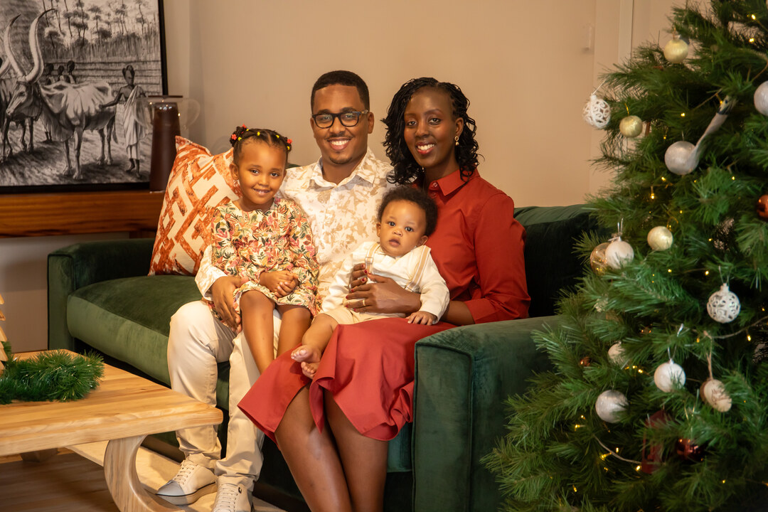Didy Elodie Rusera with her husband, daughter, and son at home in Kigali